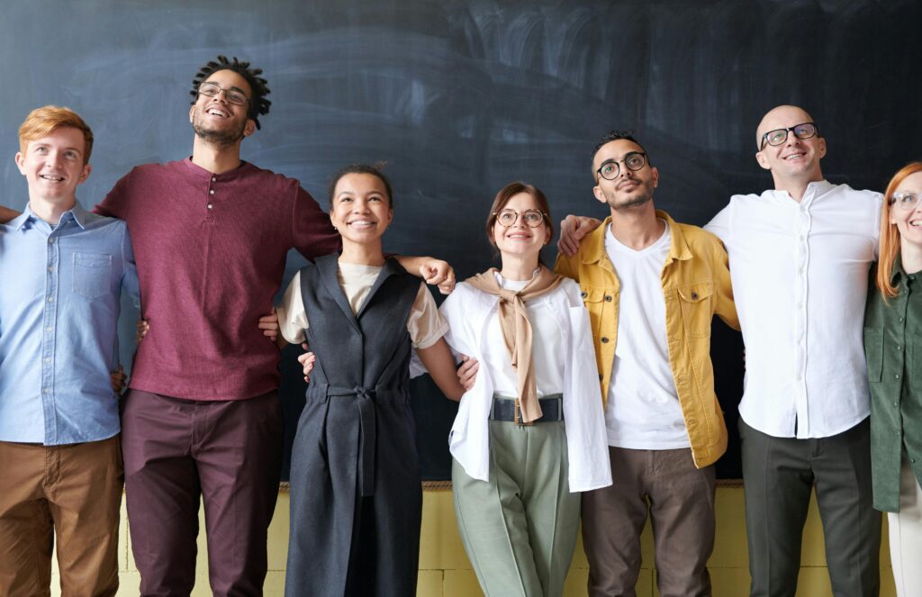 A group of people in front of a chalkboard.