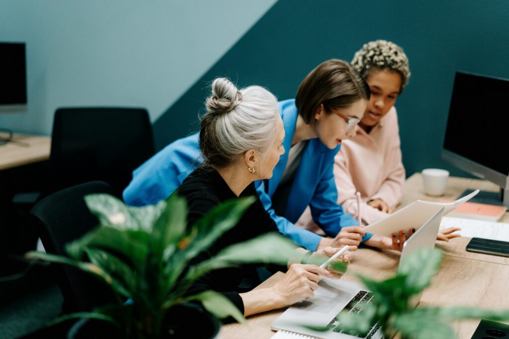 Team members collaborating at a desk.