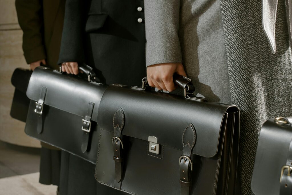 Professionals holding leather briefcases.